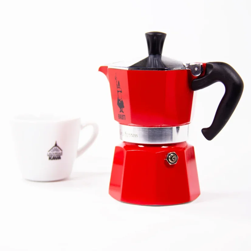 Cup of coffee and a Moka pot from the Italian brand Bialetti.