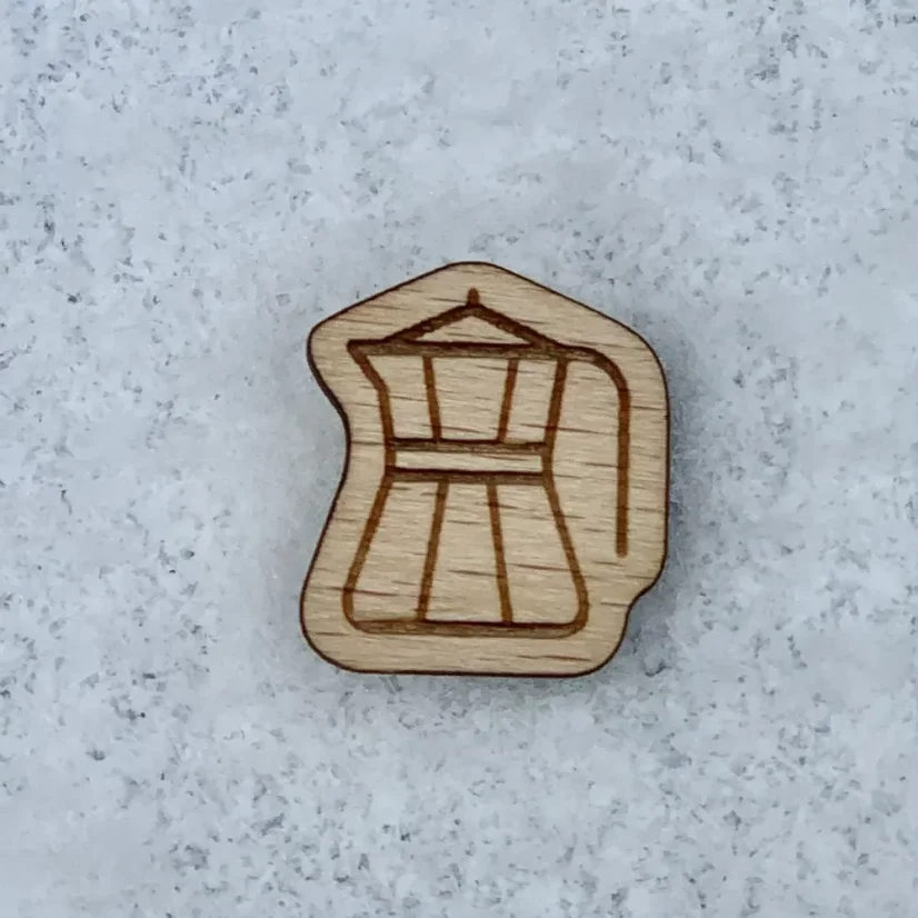 Wooden badge of the Order of the Golden Kettle with an engraved kettle symbol