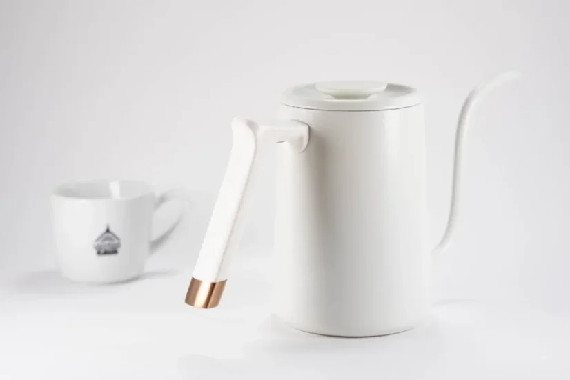 White Timemore Fish Pure Over gooseneck kettle in a rear view on a white background with a porcelain cup