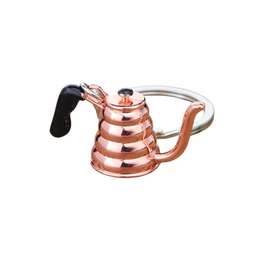 Un porte-clés en forme de théière rose est un cadeau idéal pour les amateurs de café.