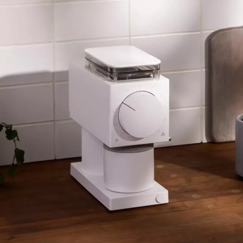 White electric coffee grinder with flat burrs ensures uniform grinding for perfect coffee preparation.