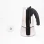 Silver moka pot with a black handle for 10 cups, on a white background with a cup of coffee, side view