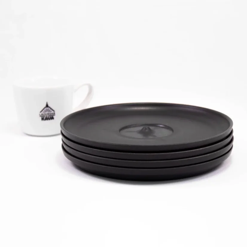 Black Huskee saucer, 4 pieces stacked on a white background with a coffee cup.