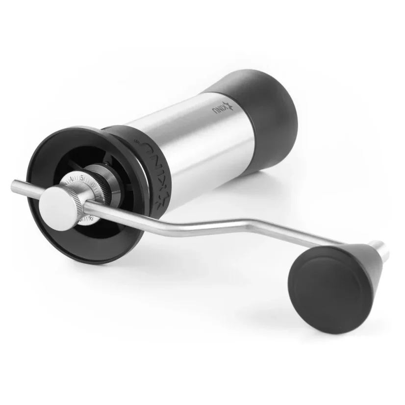 Manual coffee grinder lying on the table in silver, Kinlo M47 Phoenix with a burr size of 47mm.