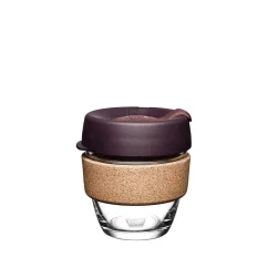 Glass KeepCup with a red lid for coffee on the go.