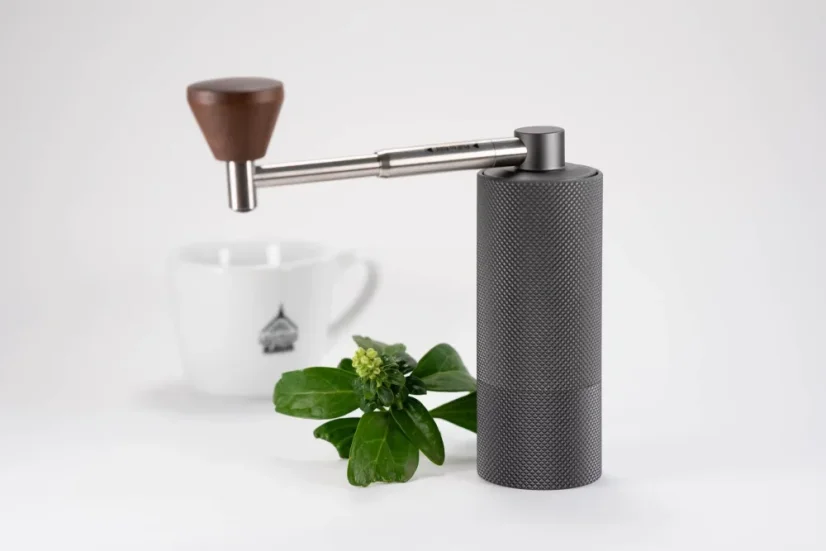 Timemore Nano Grinder mit Tasse Kaffee und Pflanze