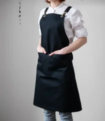 Black barista apron with straps, ideal for professional baristas.