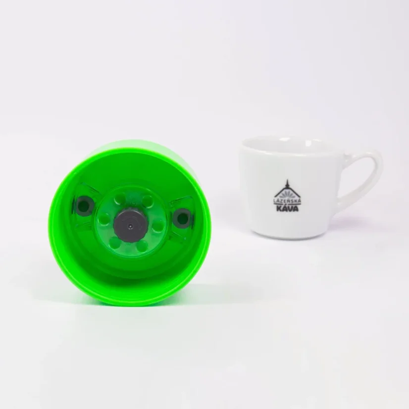 Detail of the lid of the thermal mug from the underside with coffee in the background.