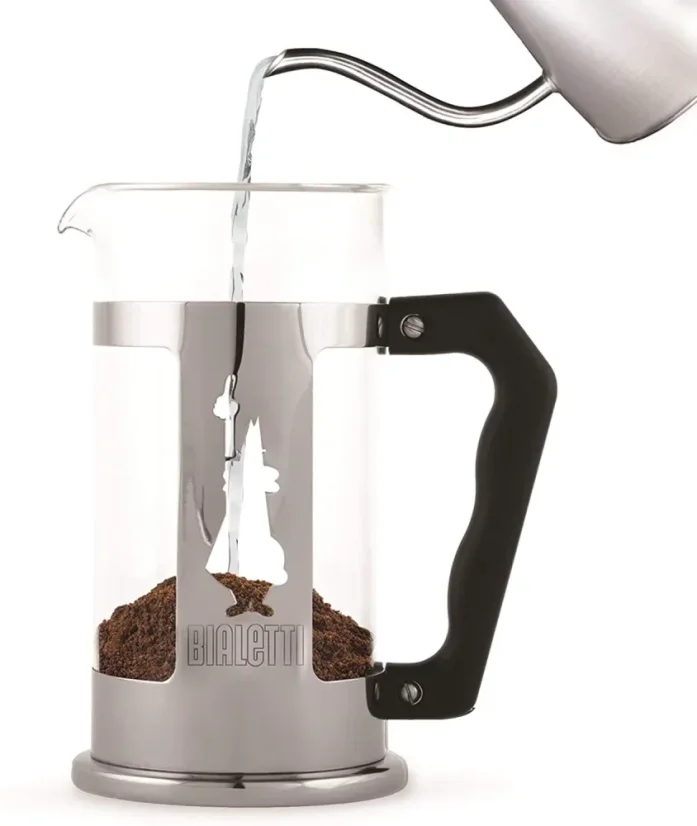 Pouring hot water into the Bialetti Preziosa French Press as the second step in coffee preparation.