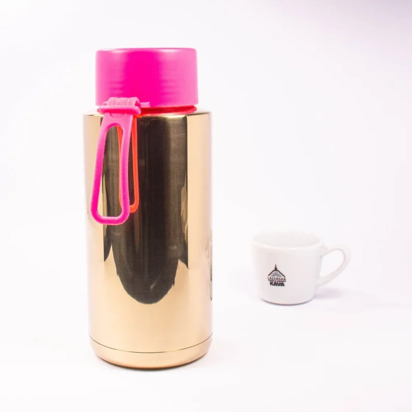Ceramic thermos from the back with coffee in the background