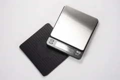 Silver digital scale on white background with rubber mat