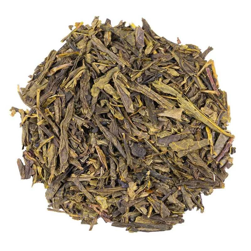 Loose green tea China Sencha on a white background, top view