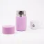 Open pink thermal bottle with a capacity of 295 ml on a white background with a cup of coffee