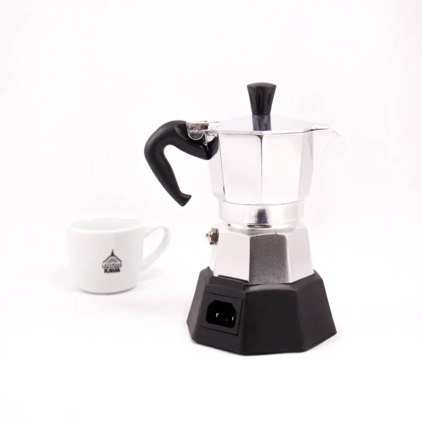 Side view of a silver Bialetti Moka Elettrika Standard mocha pot with a heat source, complemented by a cup with coffee-themed motifs in the background.