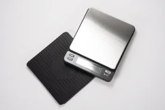 Silver digital scale on white background with rubber mat Silver digital scale on white background with rubber mat