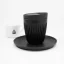 Black Huskee saucer with a cup and lid on a white background with a coffee cup. Black Huskee saucer with a cup and lid on a white background with a coffee cup.