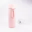 Ceramic thermos from the back with coffee in the background